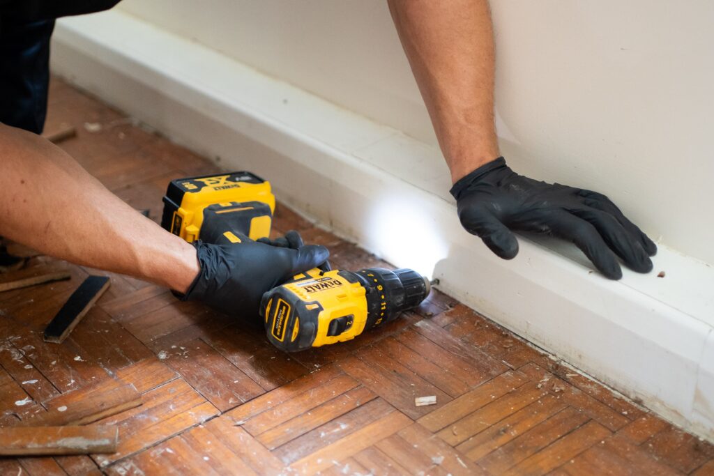 Technician Carrying Out Skilled Work During Disaster Care Property Reinstatement 