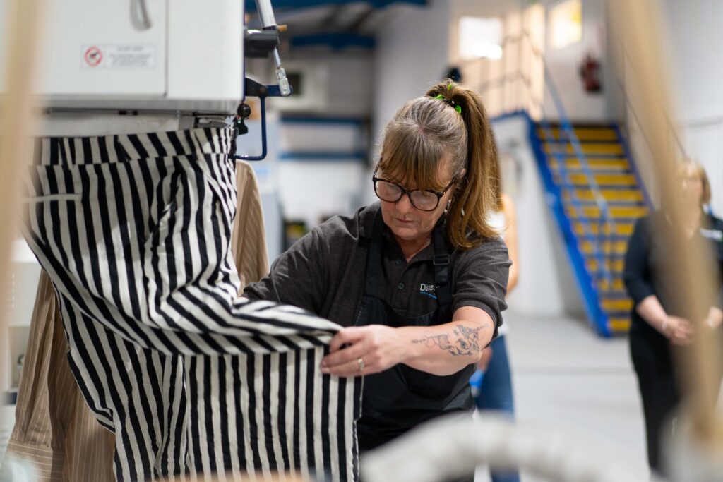 Disaster Care Contents Specialist Handling Clothing with Care During Soft Contents Restoration